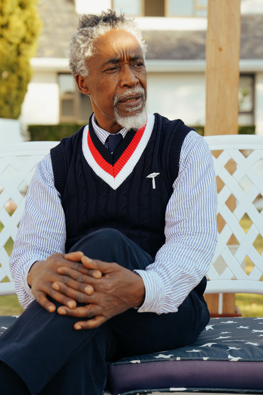 Navy blue cable-knit sweater vest.