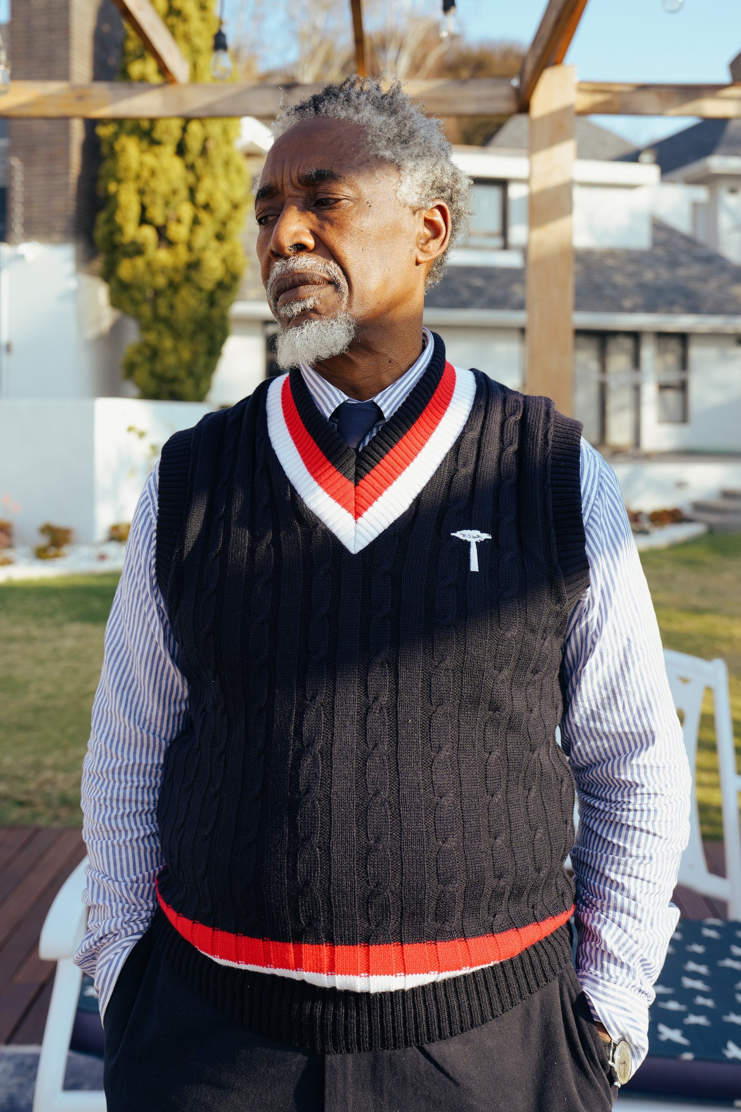 Navy blue cable-knit sweater vest.