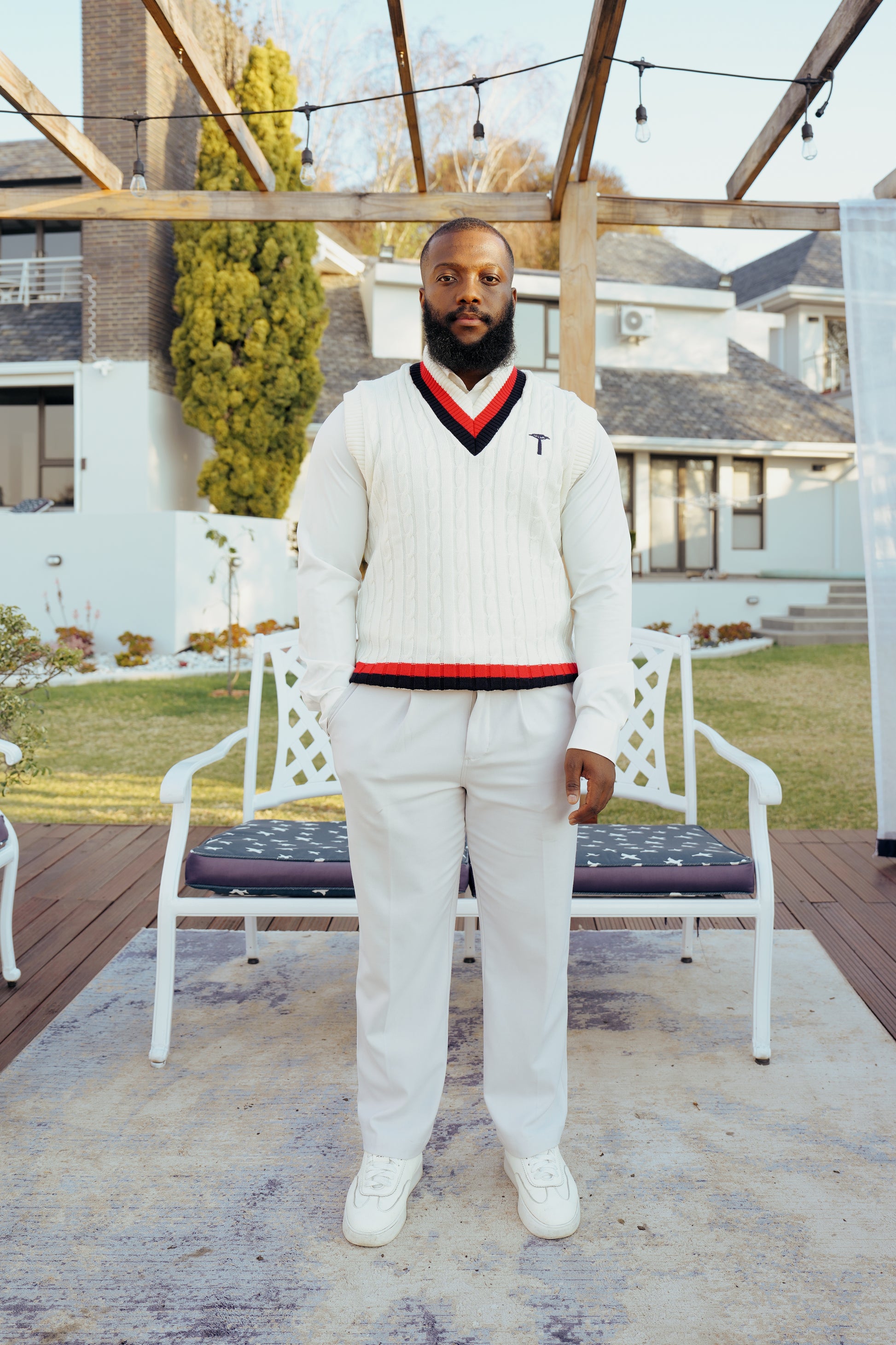 white knit crewneck sweater with a red and navy V-neck collar