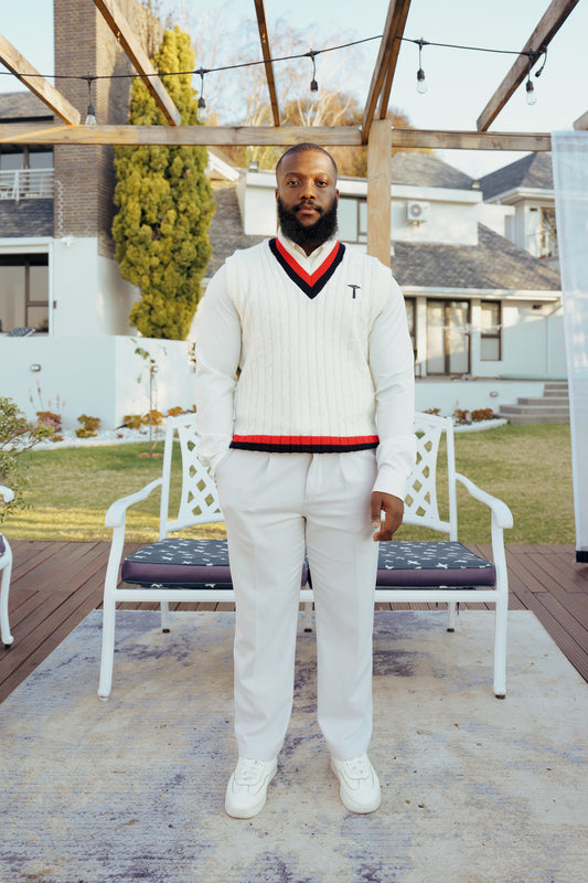 white knit crewneck sweater with a red and navy V-neck collar