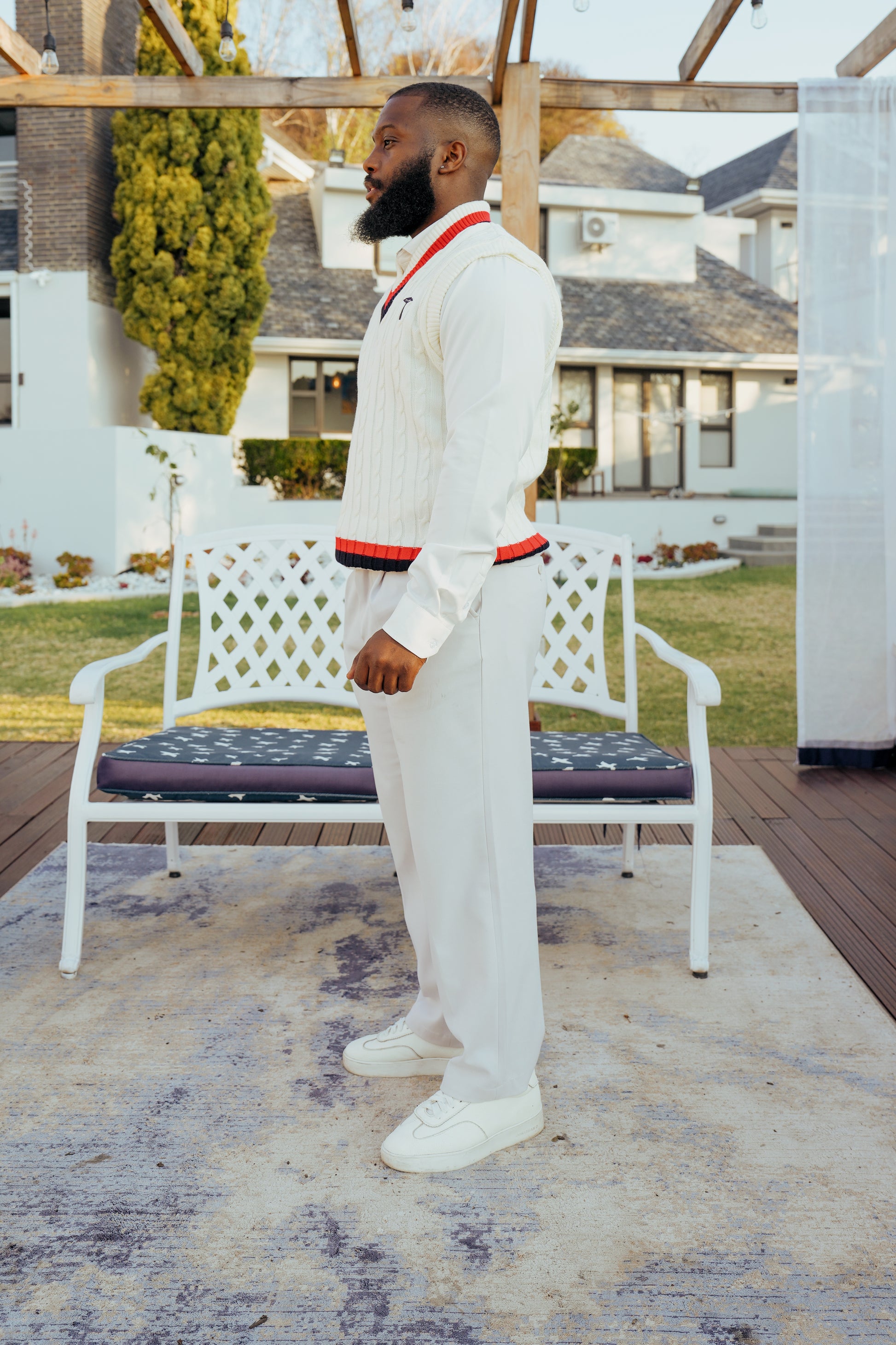 white knit crewneck sweater with a red and navy V-neck collar