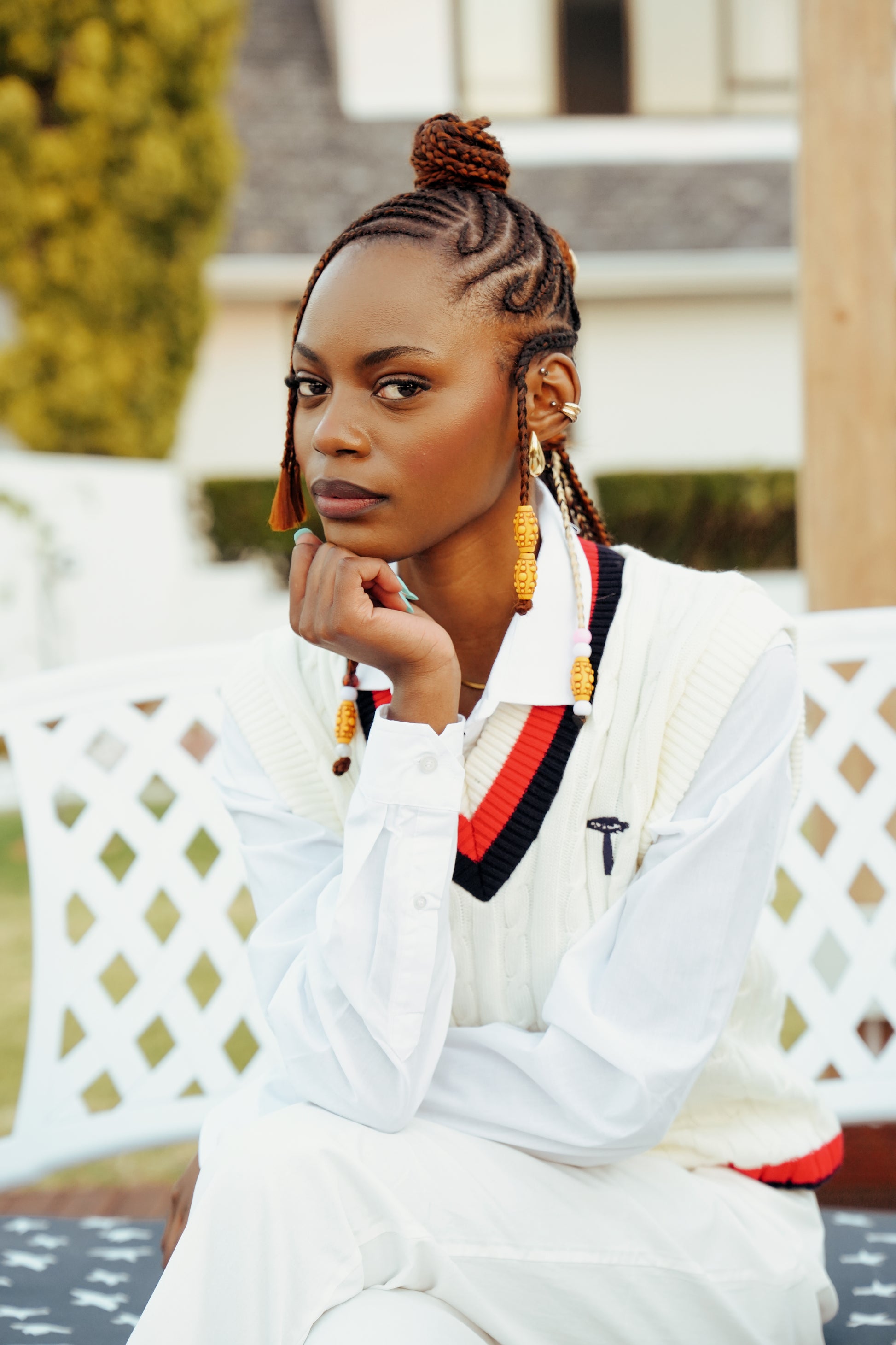 white knit crewneck sweater with a red and navy V-neck collar