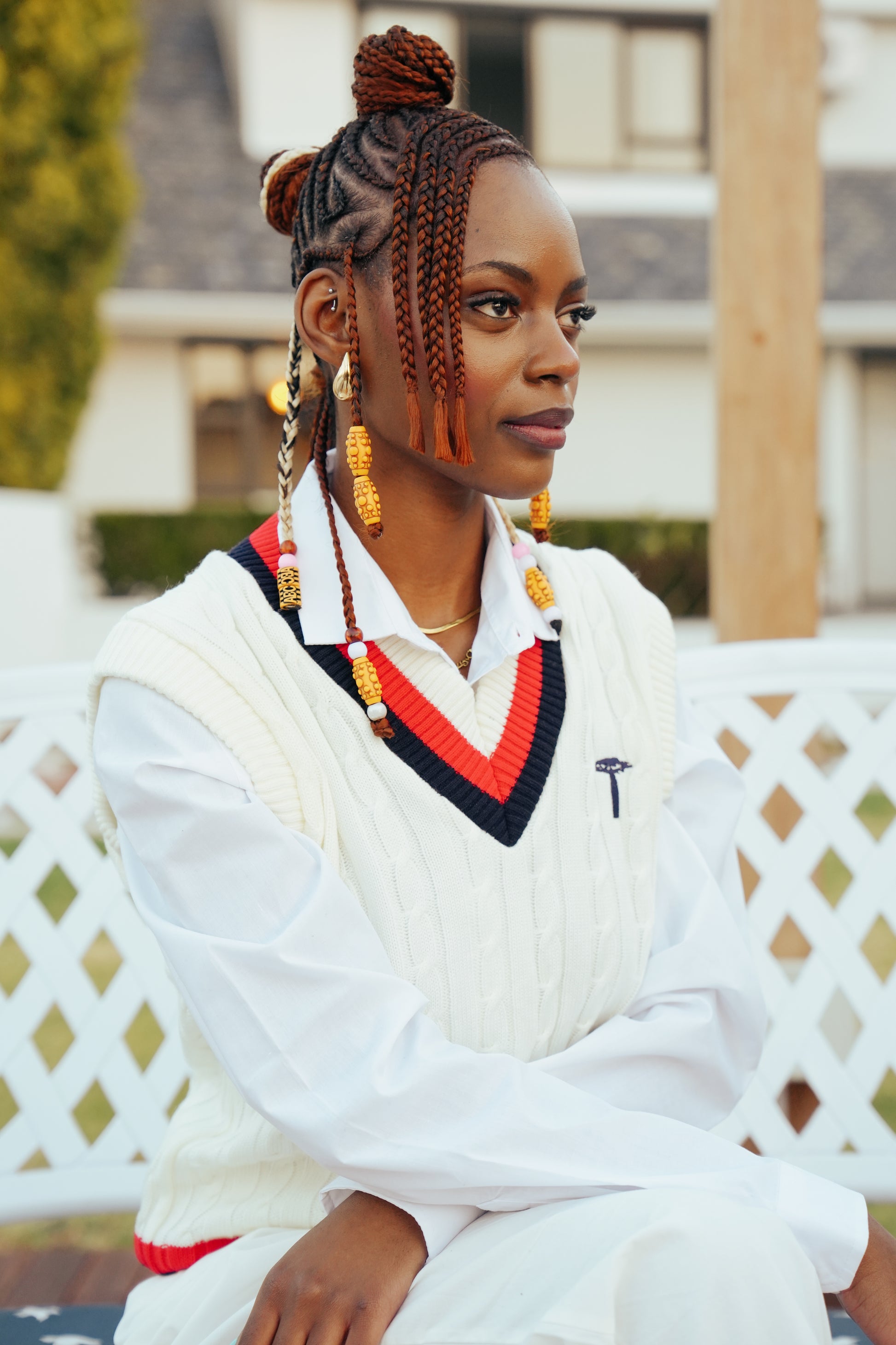 white knit crewneck sweater with a red and navy V-neck collar